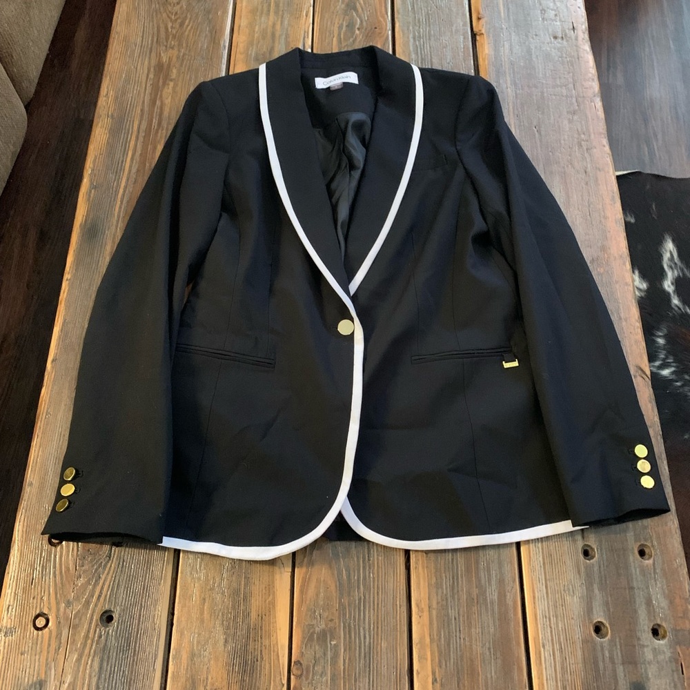 Black, white, and gold blazer
